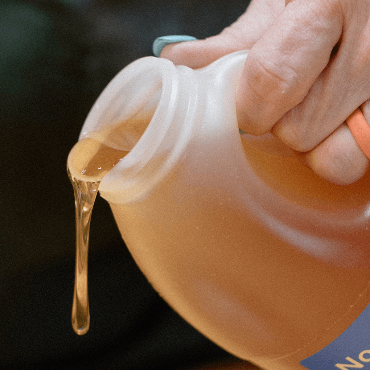 Someone pouring clover honey.