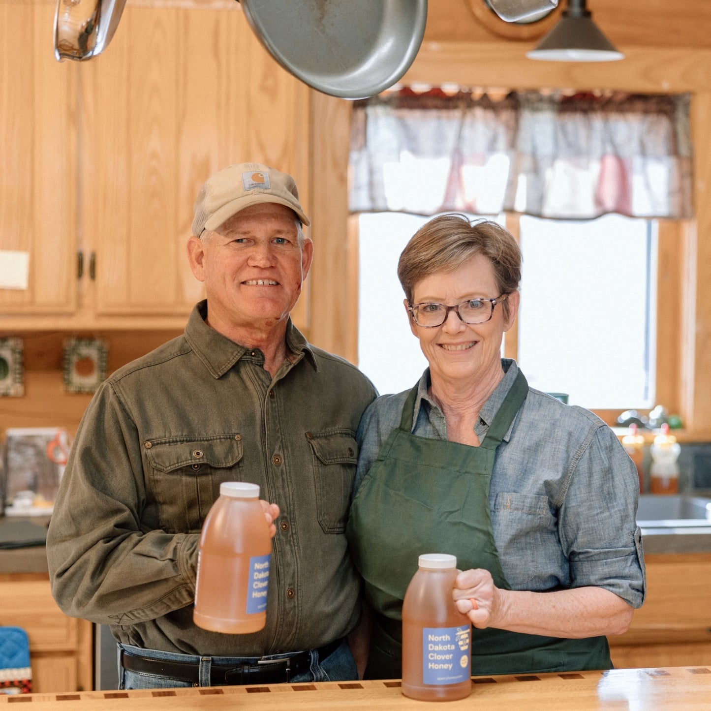 Mark and Becca Sperry holding clover honey.