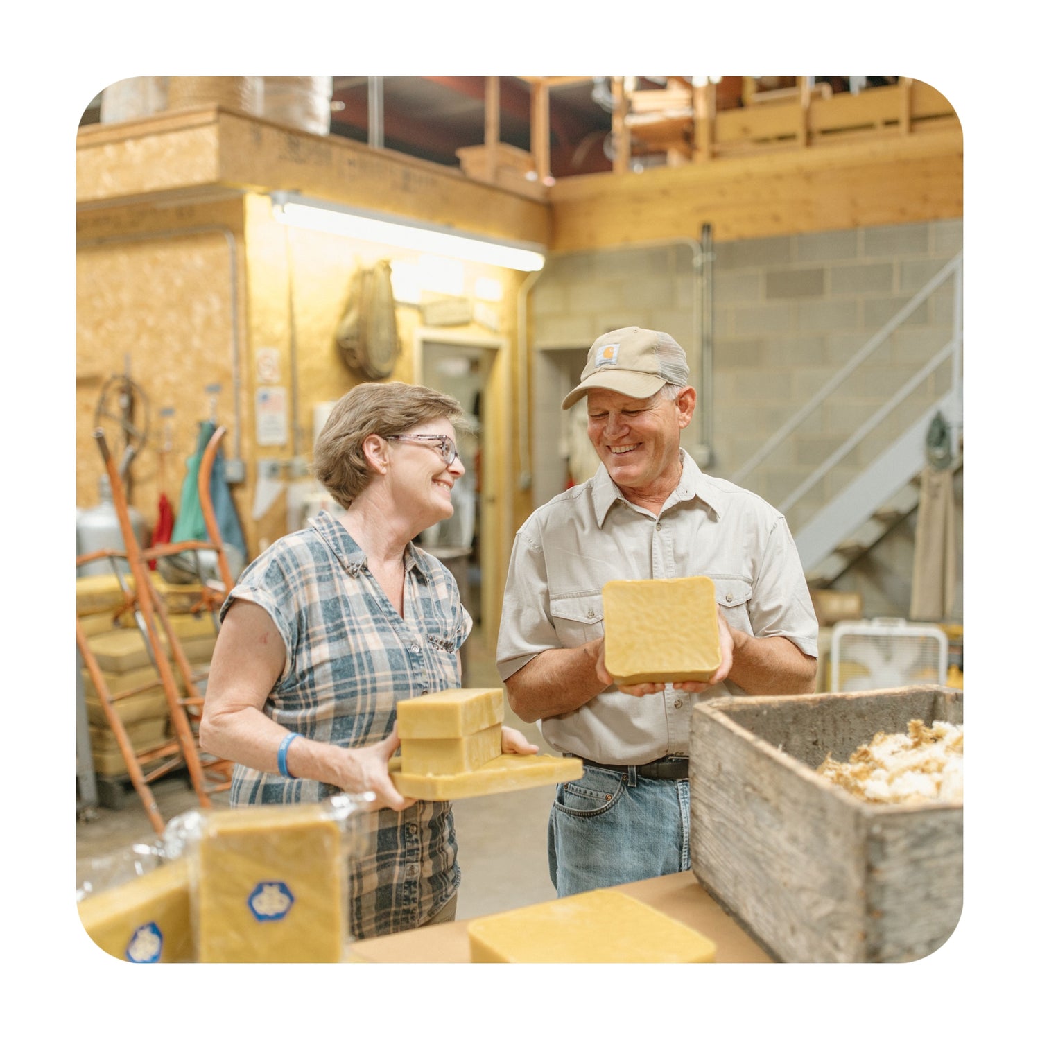 Mark and Rebecca holding beeswax blocks.