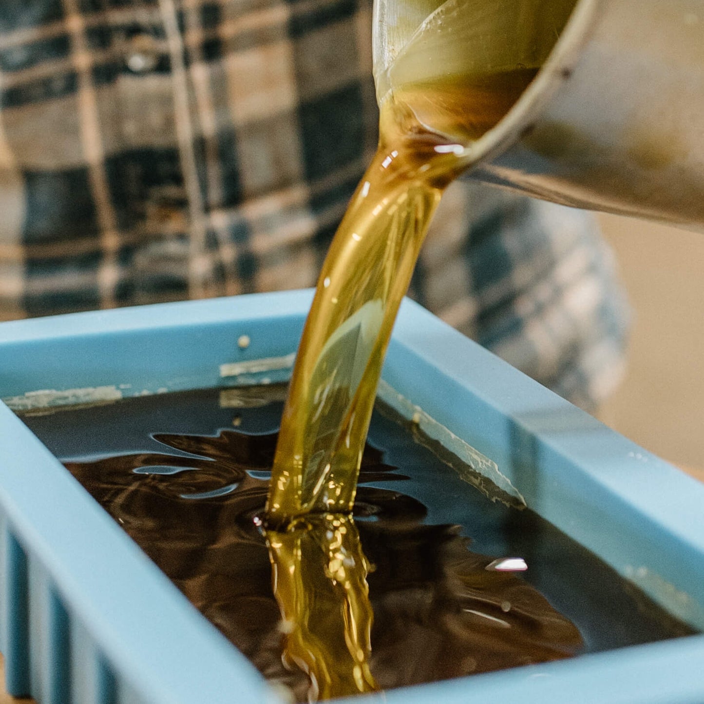 Rebecca Sperry pouring molds for a bulk beeswax order.