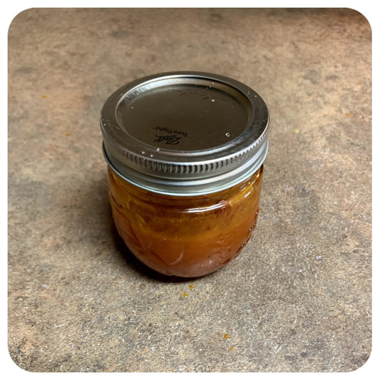 A closed jar of honey buffalo sauce