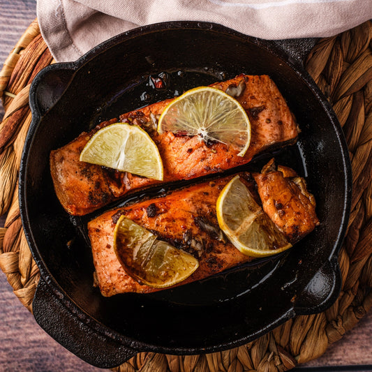 Honey glazed salmon in an iron skillet.