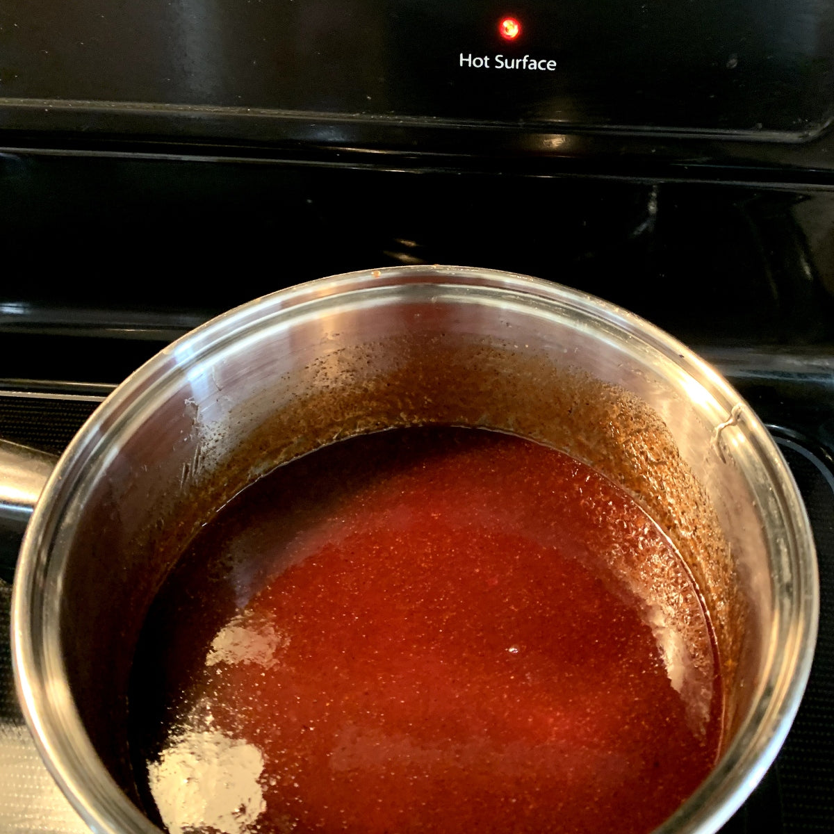 Honey chipotle sauce in a saucepan on the stove.