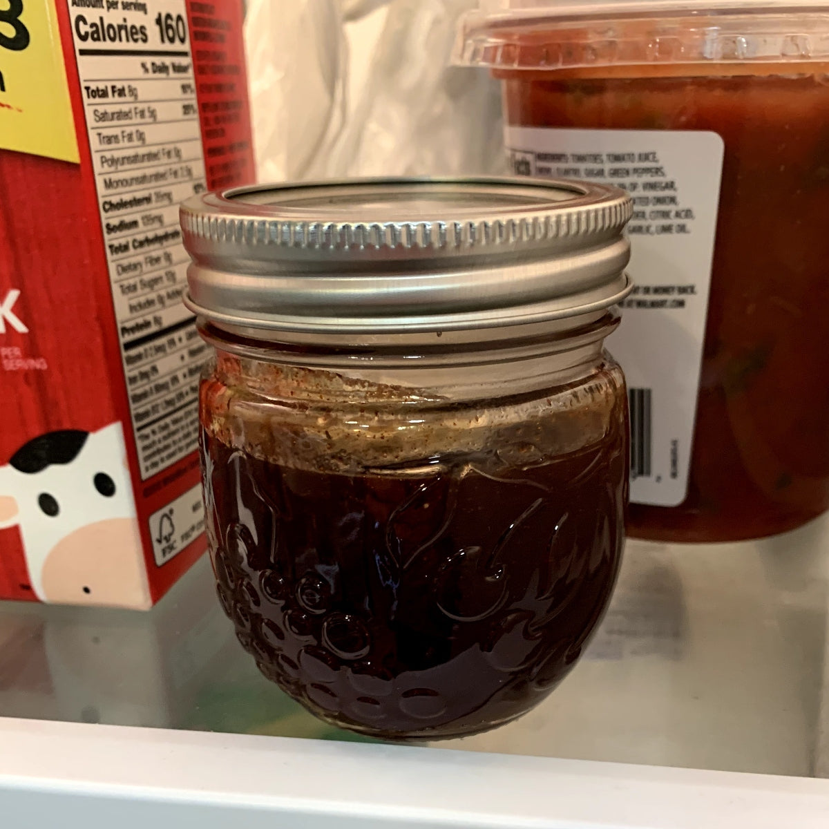 Honey chipotle sauce in a jar, sitting in the fridge.