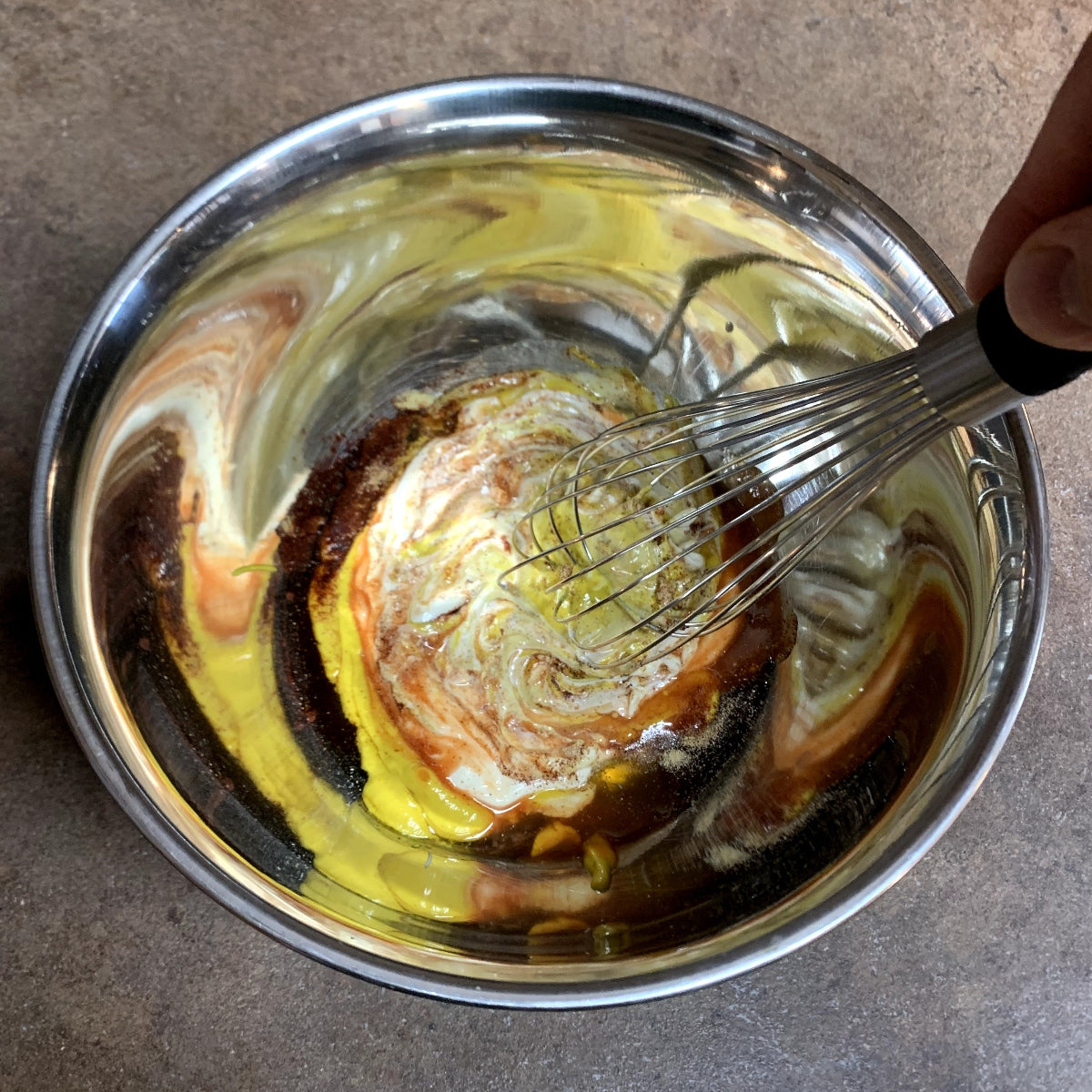 Mixing the ingredients for honey gold sauce in a bowl.