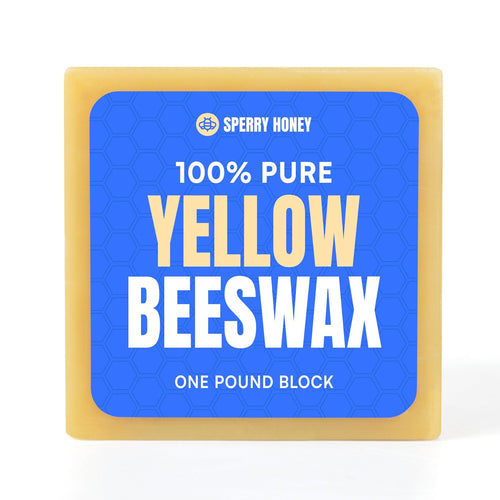 Block of 100% pure yellow beeswax with Sperry Honey branding on a blue label.