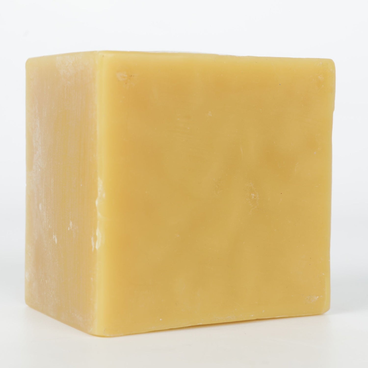 Beeswax block on a white background