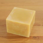 Block of beeswax on a wooden surface