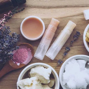 Wooden surface with skincare products and lavender flowers