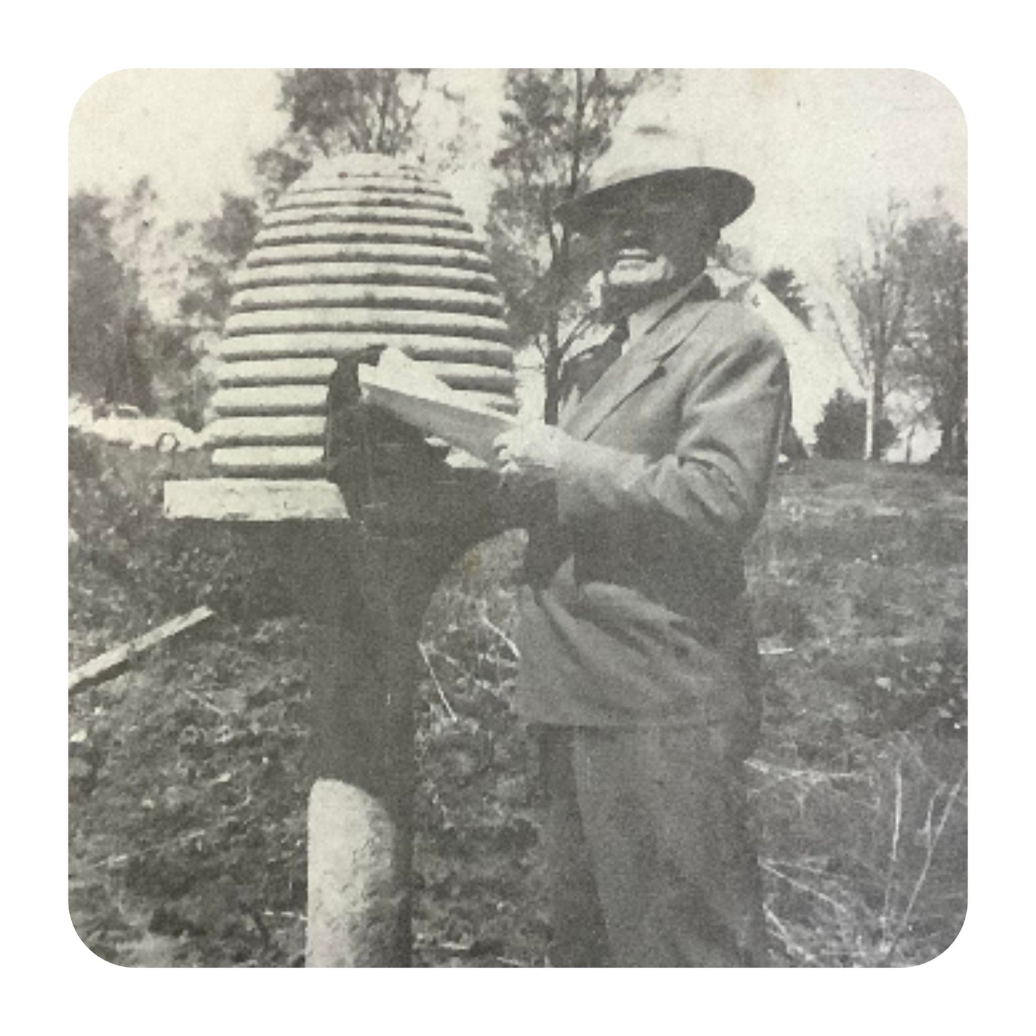 Everett Sperry beside a beehive.