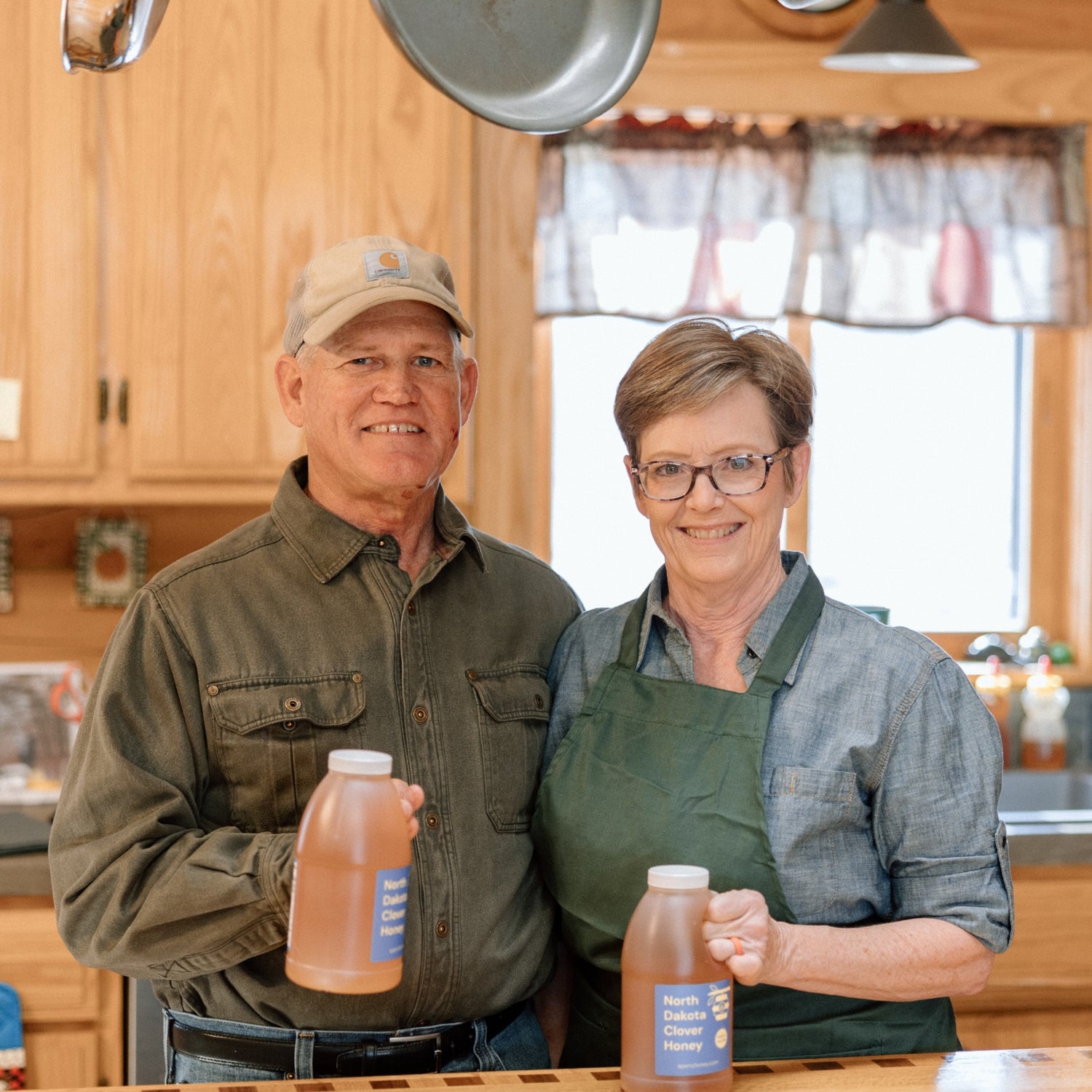 Mark and Rebecca Sperry holding bottles of gluten-free honey.