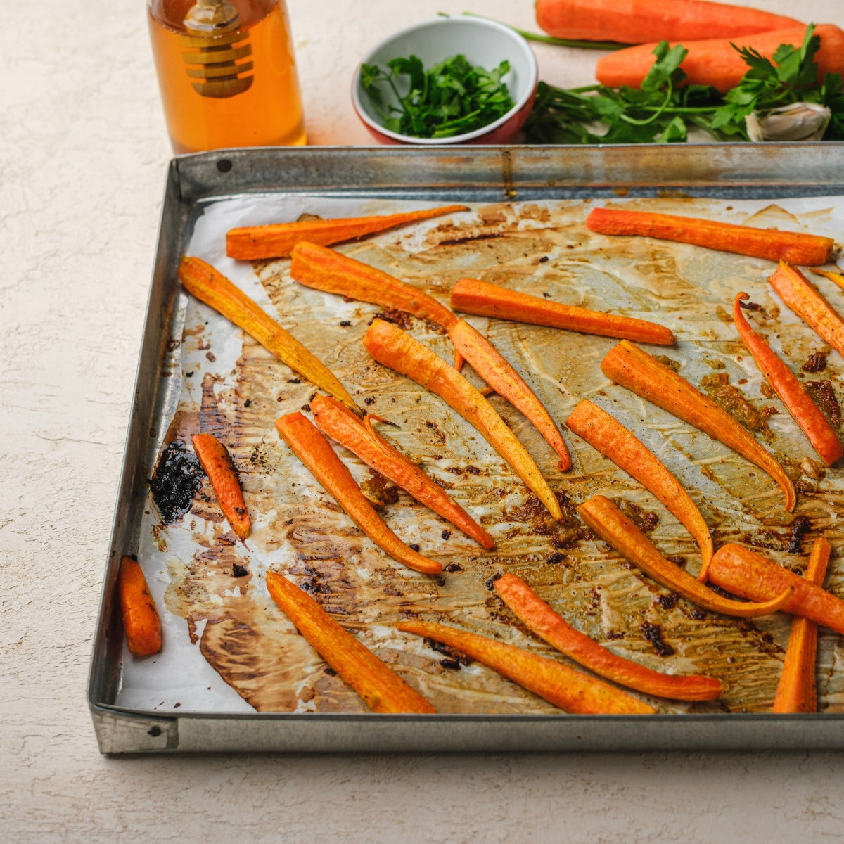 Honey glazed carrots on a sheet pan.