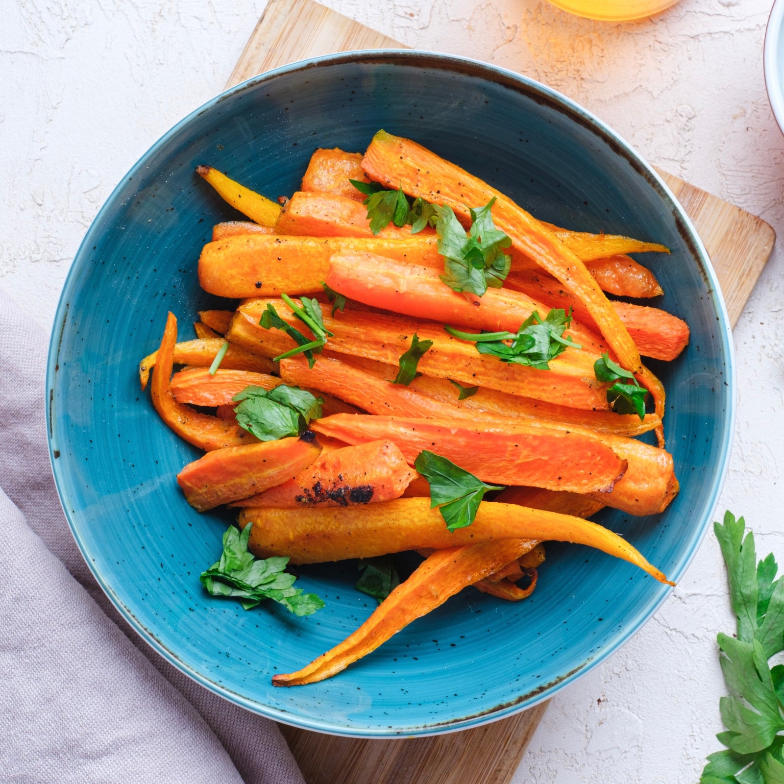 honey glazed carrots in a blue bowl