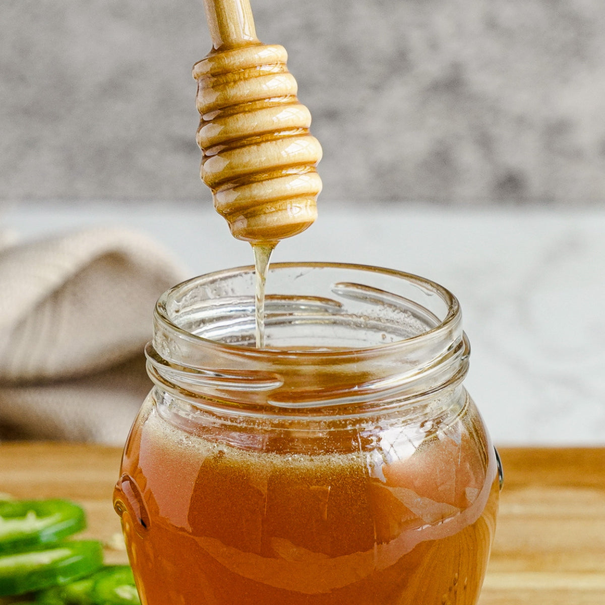 Hot honey being drizzled into a jar.