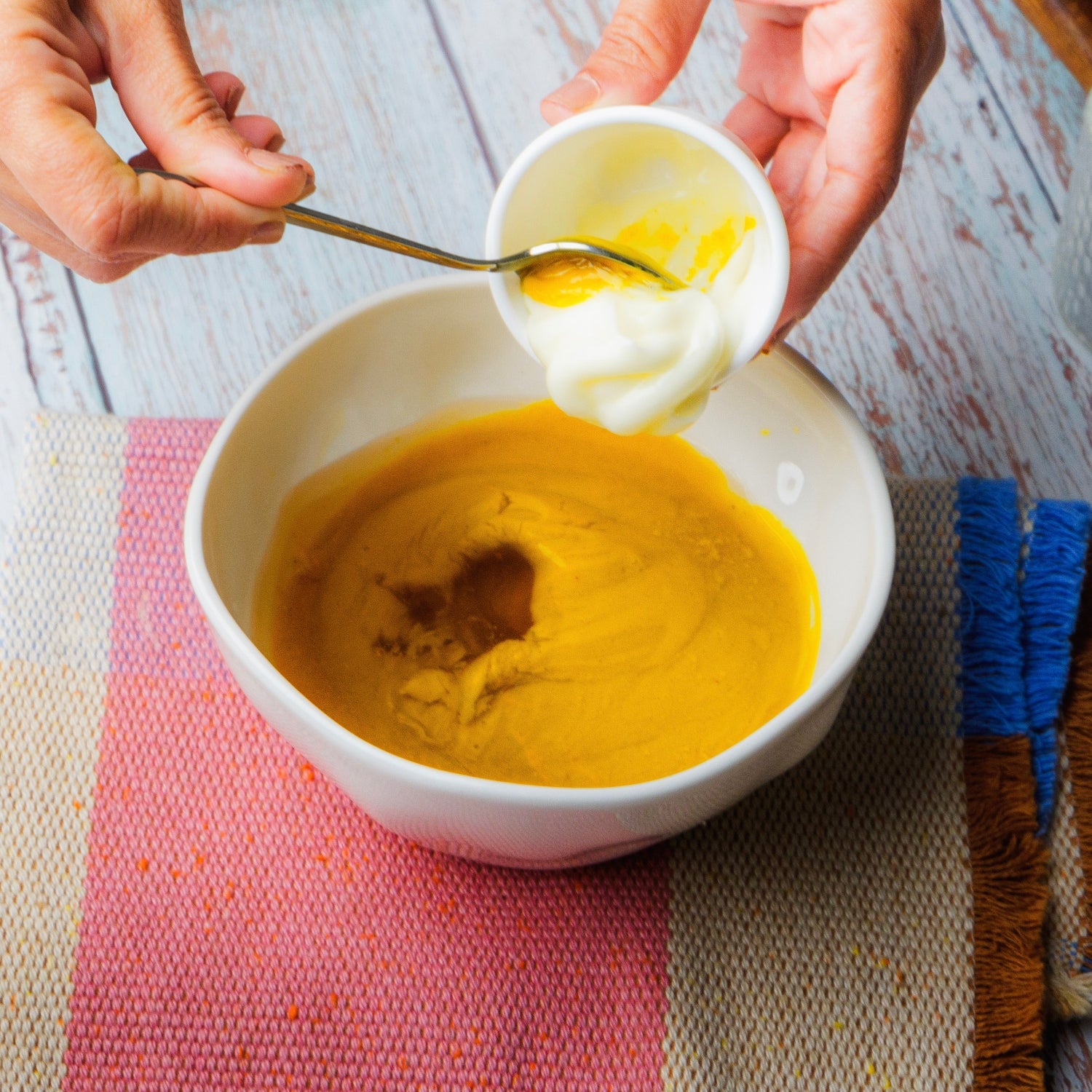 Pouring mayonnaise into a honey mustard.