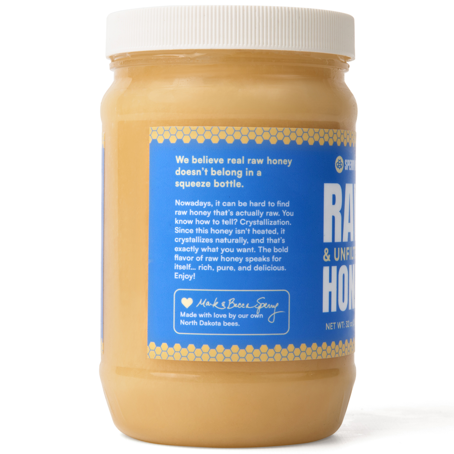 Jar of raw honey with a blue label on a white background