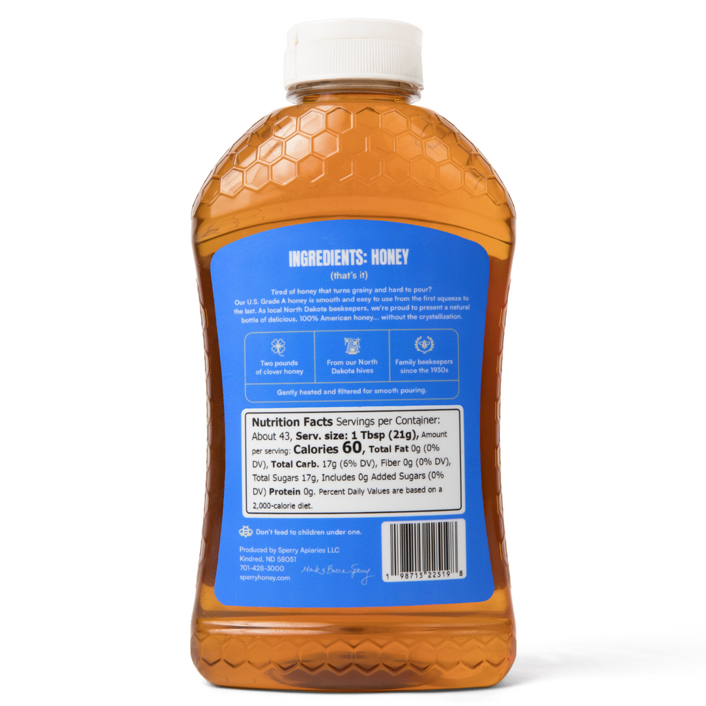 Bottle of honey with a blue label on a white background