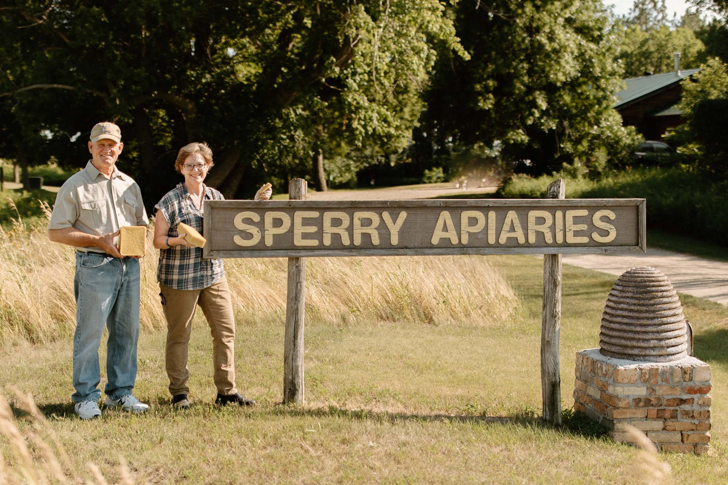Mark and Becca Sperry standing by their Sperry Apiaries sign, where the beeswax is made.
